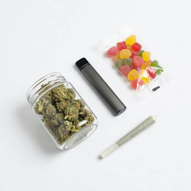 Cannabis flower in a jar, a vape pen, gummies, and a pre-roll on a white background